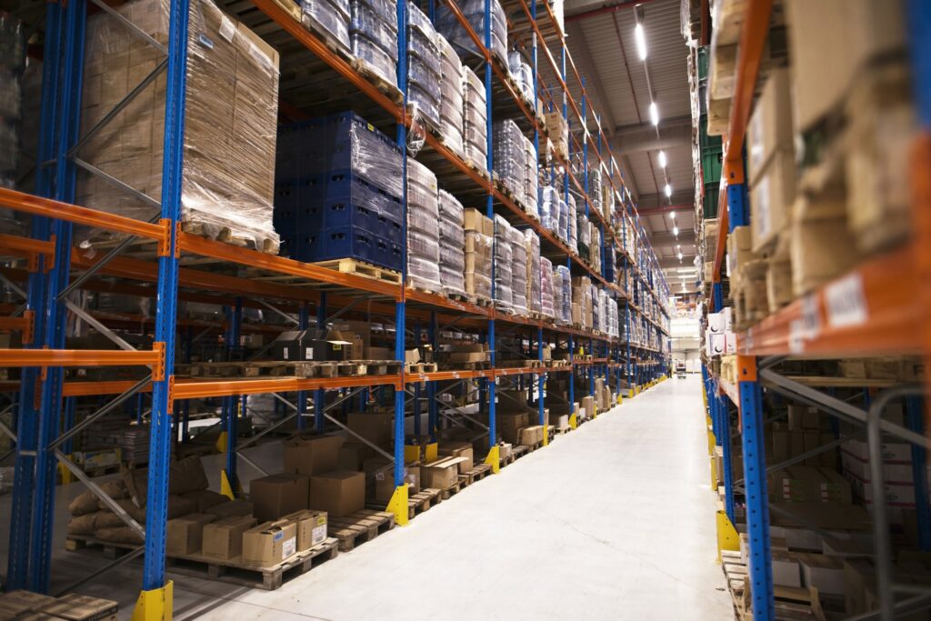 Interior large distribution warehouse with shelves stacked with palettes goods ready market 1024x683